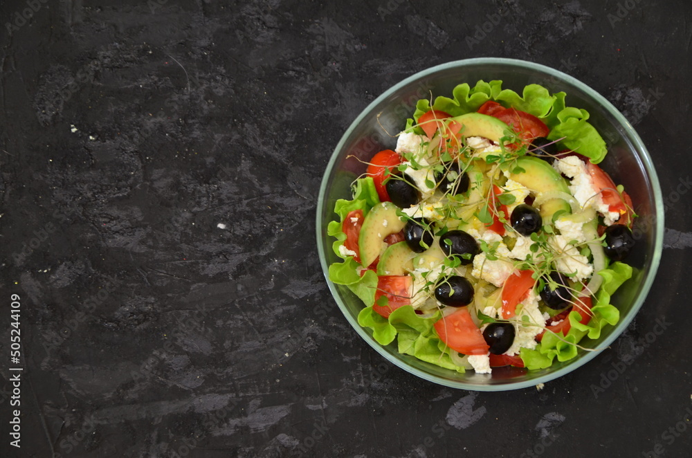 Healthy salad in a bowl with olives, tomato, cheese, microgreens and avocado served for breakfast. healthy, delicious food with vitamins, vegetarian food, few calories. diet food