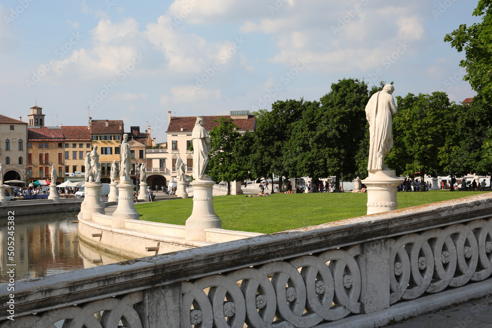 public park in Padua called Prato della Valle with statues and the stone bridge leading to the island