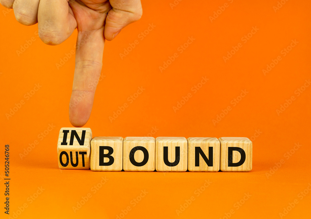 Inbound or outbound symbol. Businessman turns wooden cubes and changes ...