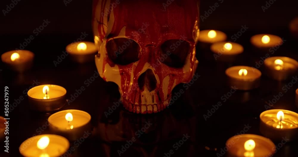 Blood stained skull against dark background closeup Blood stained skull against dark background closeup