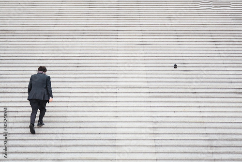 sequence man climbing stairs next to a pigeon