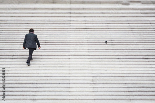 sequence man climbing stairs next to a pigeon