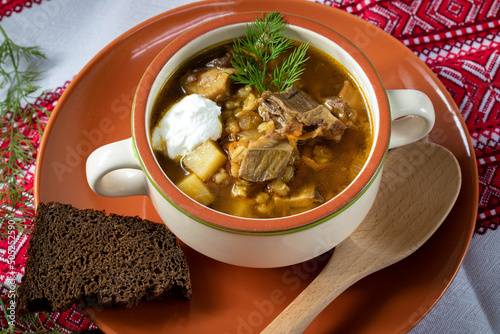Mushroom soup of porcini mushrooms with pearl barley, seasoned with sour cream. Russian mushroom soup.
