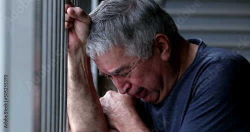 Person suffering from mental illness crying in despair photo