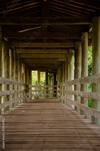 Wooden structure  with bridge  that passes over a lake. 