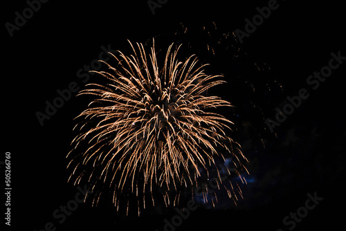 Foto Firework over the ordinary European city at night near water, orange