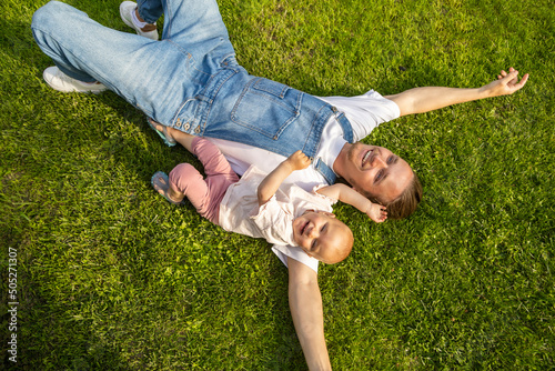 man taking a rest in a garden with his doughter
