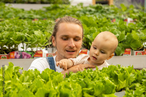 father and daughter are selecting plants for planting