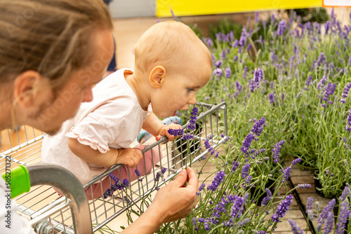 father and daughter are selecting plants for planting