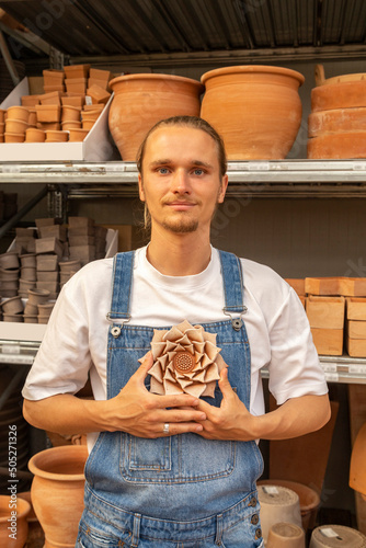 young farmer with a lotus sculpture lilke an anahata chalra. Meditation, enlightenment concept