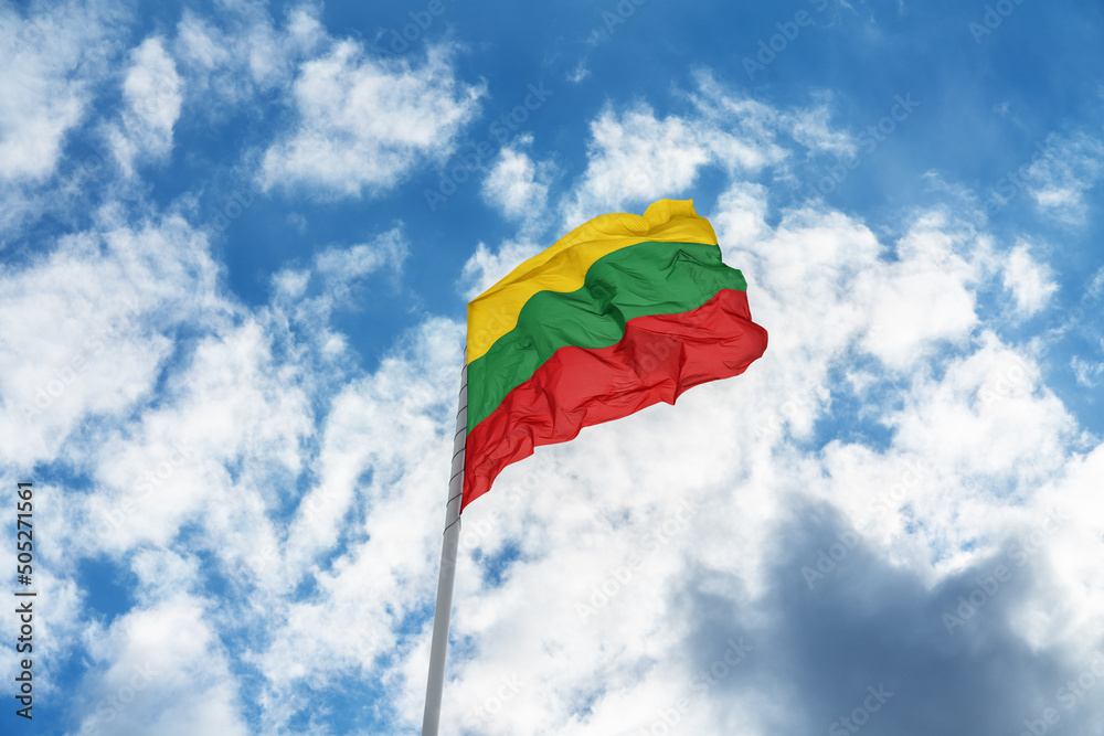 Flag of Lithuania is waving in front of blue sky and clouds Flag of Lithuania is waving in front of blue sky and clouds