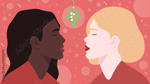 A kiss under a mistletoe branch, at a Christmas party. Two girls are going to kiss. An international lesbian couple celebrates the holiday. Love is love. A date between two women