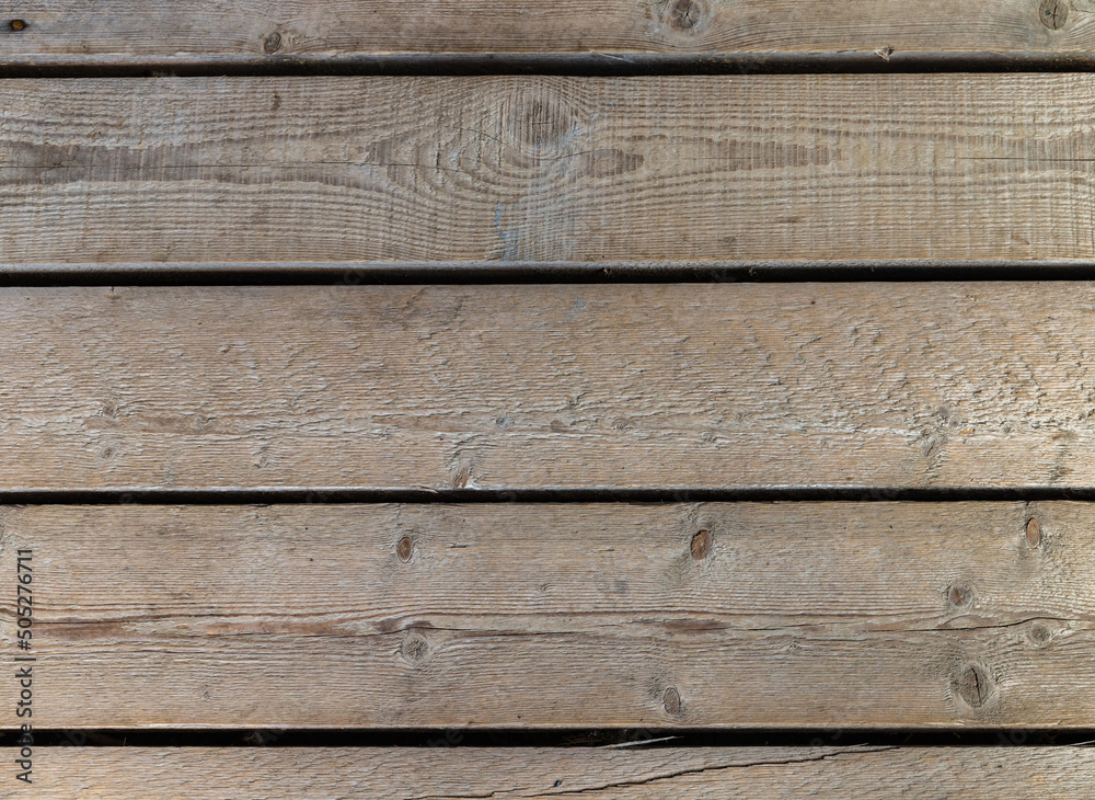 Old wooden wall made of rough uncolored boards. Background photo texture Old wooden wall made of rough uncolored boards. Background photo texture
