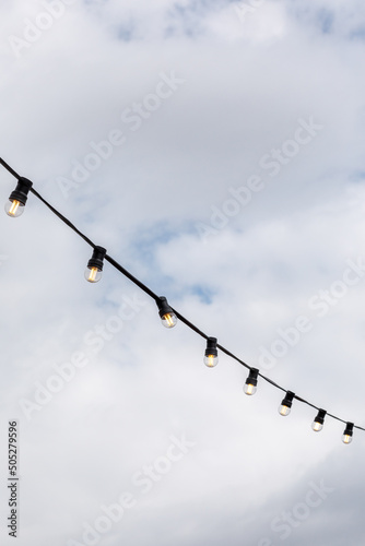 light bulbs garlands on a background of blue sky 