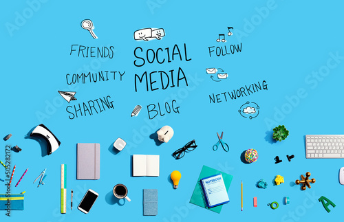 Social media theme with collection of electronic gadgets and office supplies