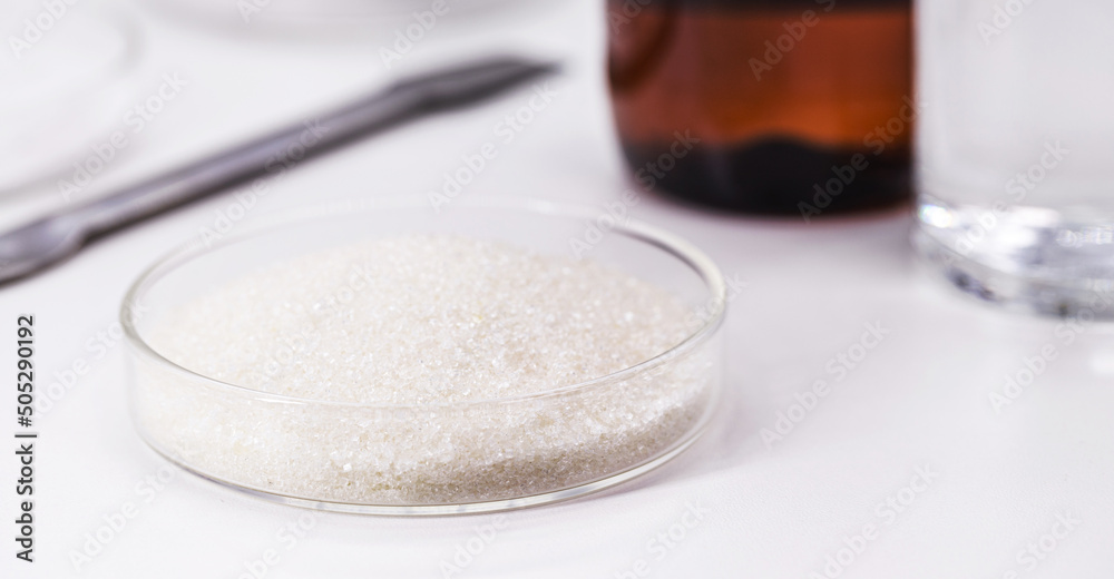 crystals of acetylsalicylic acid in petri dish, chemical component used to make tablets of acetylsalicylic acid or aspirin crystals of acetylsalicylic acid in petri dish, chemical component used to make tablets of acetylsalicylic acid or aspirin
