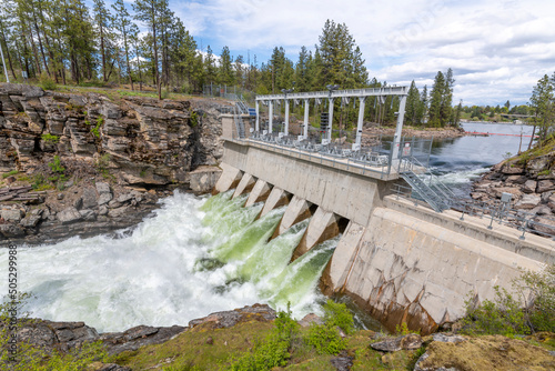 The dam at Falls Park along the Spokane River with roaring rapids in the rural town of Post Falls, Idaho.