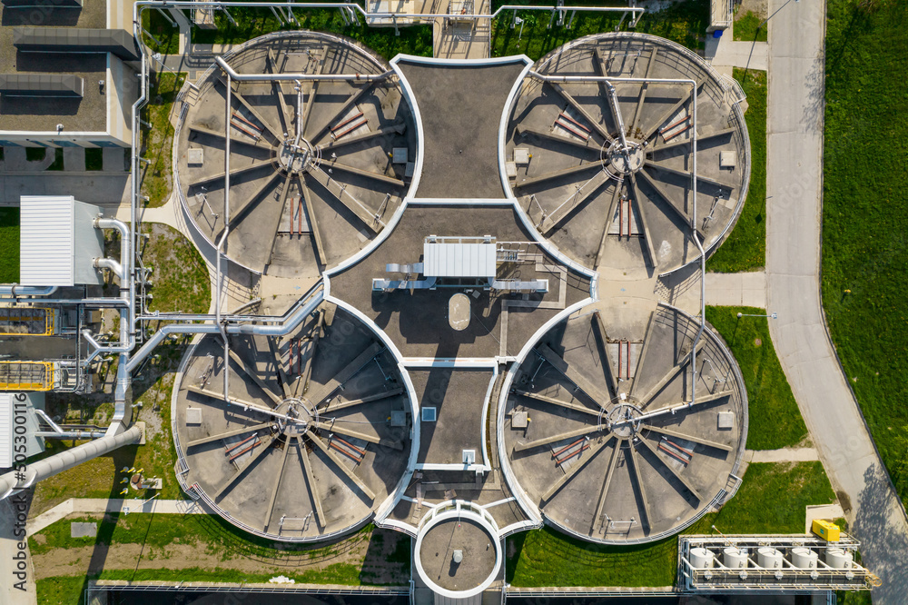 Modern urban wastewater treatment plant. Water purification plant, automatic process of removing chemicals, solids and gases from contaminated water. Water cleaning facility outdoors. Aerial view.