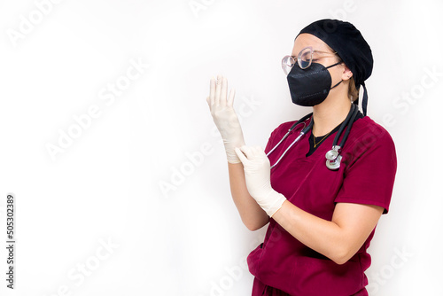 Nurse in burgundy uniform going about her hospital duties on a white background for copy space