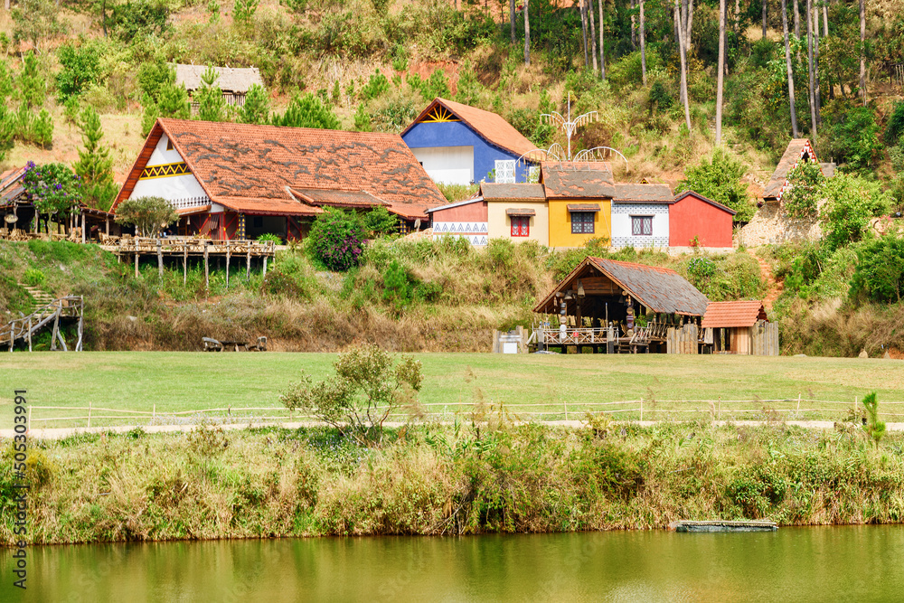 Rustic houses with tile roofs among green woods Rustic houses with tile roofs among green woods