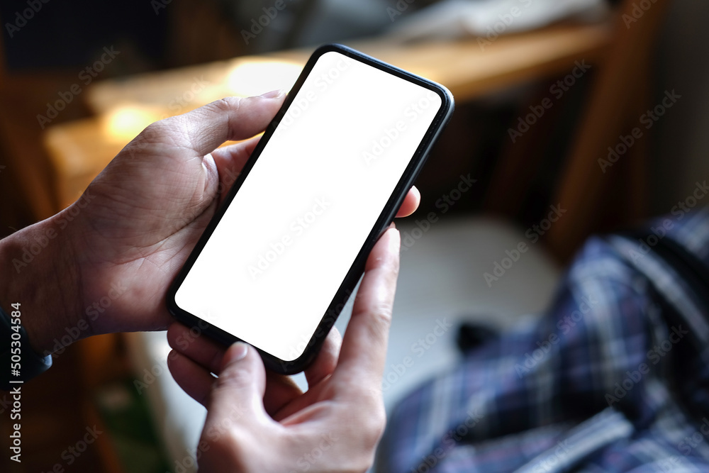 Close up view man hands holding smart phone with blank screen for advertise text.