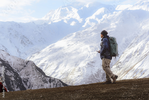 Travel man success hiking snow rock mountain.