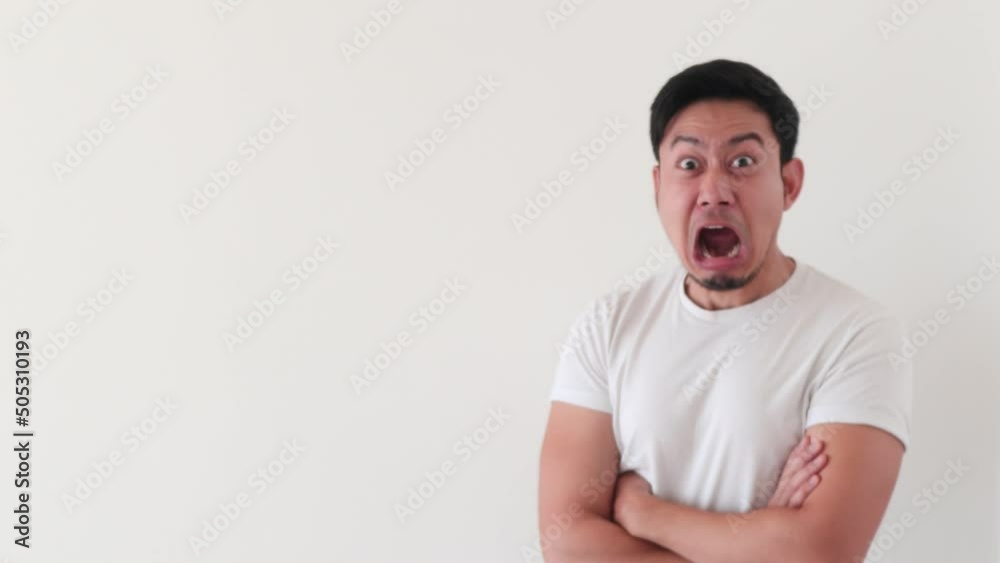 Asian man shocked as he see the surprise content on the empty space. Asian man shocked as he see the surprise content on the empty space.