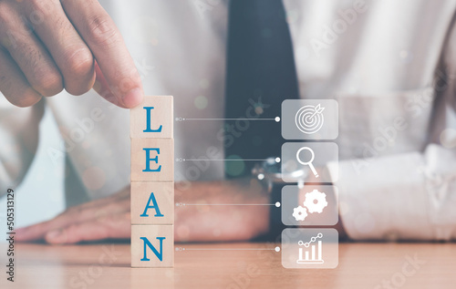 Lean Medicine Concept. Hand of a businessman arranging wood blocks with lean text icon.