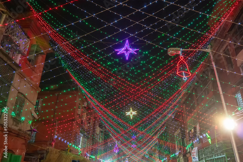 KOLKATA, WEST BENGAL, INDIA - DECEMBER 24TH 2017 : Street is decoarted with overhead lights at Bow Barracks - a famous Anglo-Indian street of Kolkata, at night. photo