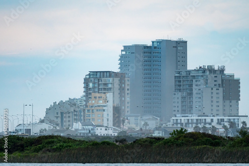 cityscape view of tall buildings, apartment blocks, condominiums at the coastal town of Bloubergstrand, Cape Town, South Africa photo