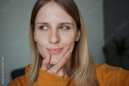 The girl displays the emotion of sly thoughtfulness