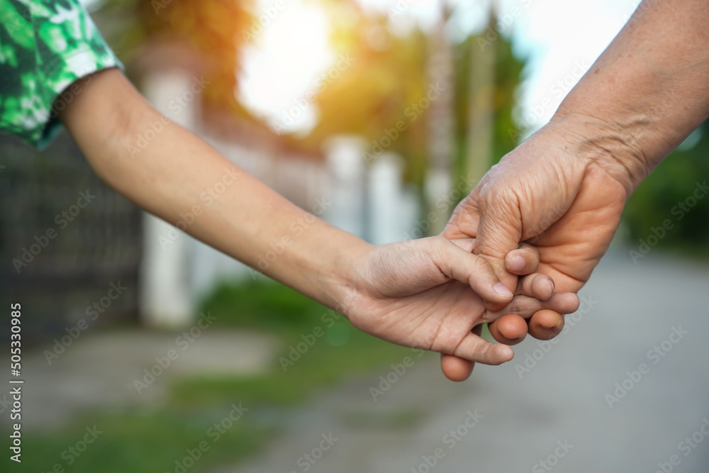 parent holds the hand of a small child parent holds the hand of a small child