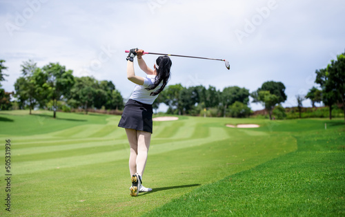Professional woman golfer teeing golf in golf tournament competition at golf course for winner © APstudio