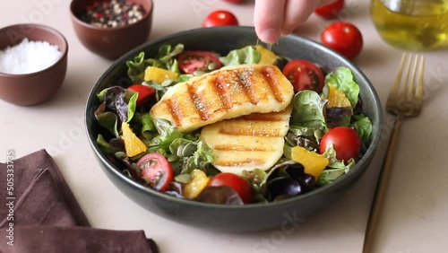 Salad with grilled halloumi cheese, tomatoes, orange and pumpkin seeds. Healthy eating. Vegetarian food. Keto diet. photo
