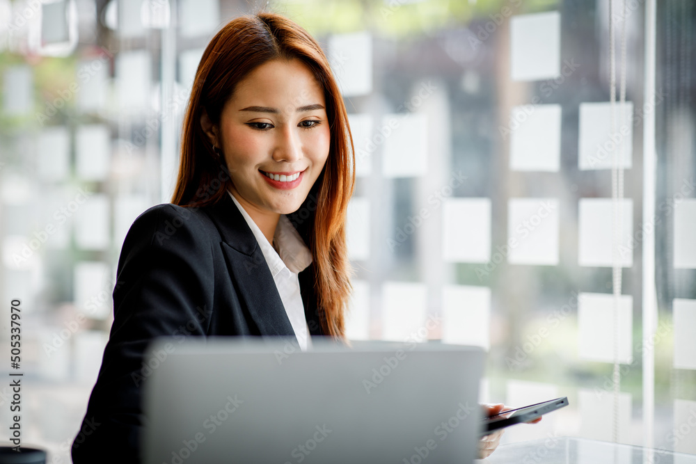 Portrait of Young Asian woman hand freelancer is working her job on computer tablet in modern office. Doing accounting analysis report real estate investment data, Financial and tax systems concept Portrait of Young Asian woman hand freelancer is working her job on computer tablet in modern office. Doing accounting analysis report real estate investment data, Financial and tax systems concept