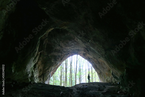 Interior view of man standing at the entrance of the Drachenhoehle (Dragon Cave) in Pernegg an der Mur in Styria, Austria. Cave near mount Rothelstein in Mixnitz in the Grazer Bergland. Grotto, Europe photo