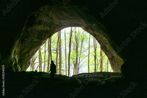 Interior view of woman standing at the entrance of the Drachenhoehle (Dragon Cave) in Pernegg an der Mur in Styria, Austria. Cave near Rothelstein in Mixnitz in the Grazer Bergland. Grotto, Europe photo