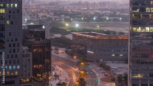 Skyline view of traffic on Al Saada street near DIFC district night to day timelapse in Dubai, UAE. photo