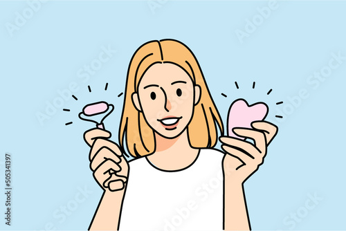 Woman hold jade roller and gua sha 