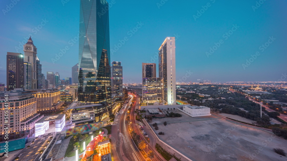 Fototapeta premium Dubai International Financial district aerial day to night timelapse. Panoramic view of business office towers.