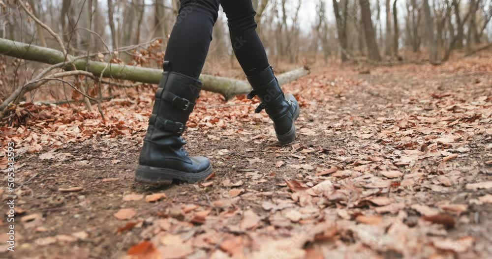Camera following woman legs while walking in forest slow motion Camera following woman legs while walking in forest slow motion