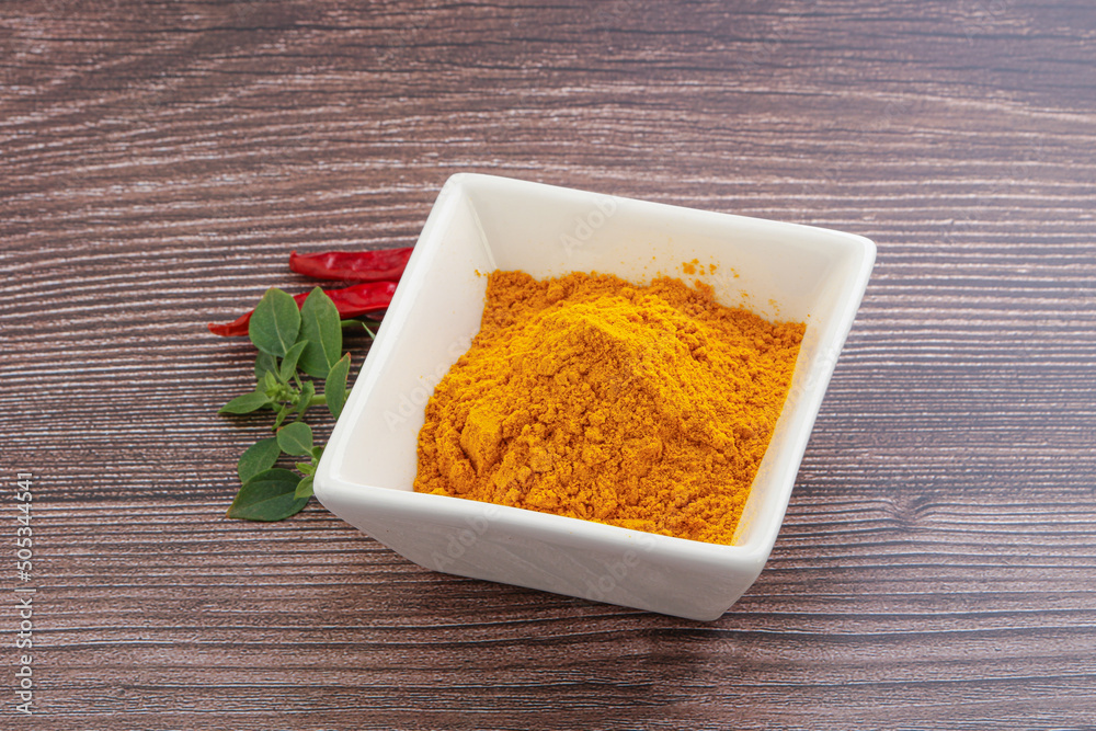 Yellow vibrant curcuma powder in the bowl Yellow vibrant curcuma powder in the bowl