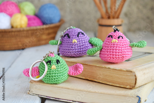 Colored crochet bird. Toy for babies or trinket.  Handmade gift. DIY crafts concept.