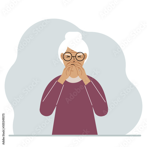 The grandmother covers his nose with his hands. The concept of a sick person, sneezes, seasonal allergies, bad smell.
