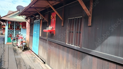 Georgetown, Penang Malaysia - May 13, 2022: The Clan Jetties of Georgetown Penang, Malaysia. Wooden villages built on stilts at the sea coast by the different clans of the Penang Chinese community. photo