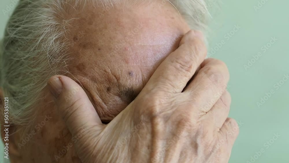 gray-haired elderly woman rubs her sore eyes with her hand. gray-haired elderly woman rubs her sore eyes with her hand.