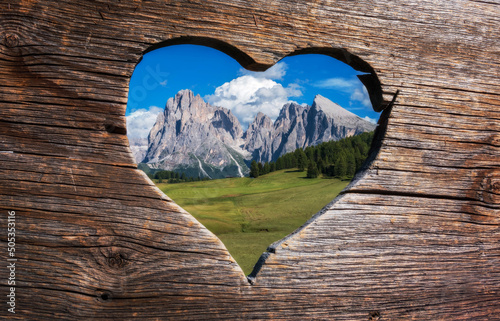 With love from the Dolomites in Italy. Heart shaped view through the bench towards the mountains. 