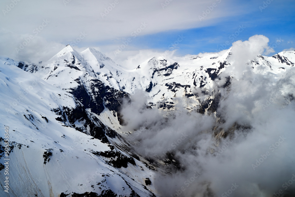 Moving clouds in front of snowy peaks of Dachstein massif, Austria
