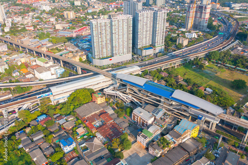 Aerial view of Bangkok Railway terminal station  BTS with skyscraper buildings in urban city  Bangkok downtown skyline  Thailand. Cars on traffic street road on highways.