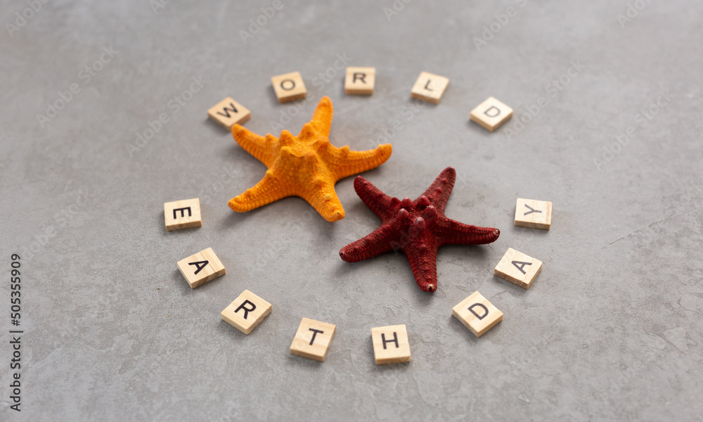 Earth day word with starfish on grey background, earth day concept Earth day word with starfish on grey background, earth day concept